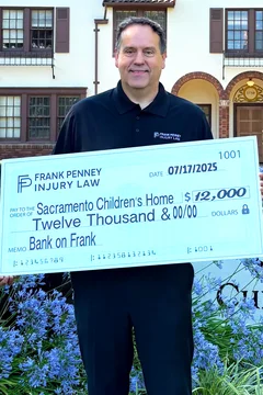 Frank Penney presenting a $12,000 donation check to the Sacramento Children's Home