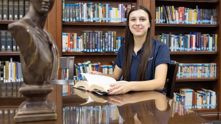A John Adams Academy student reading in the school library